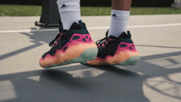 View of Trae Young's black and orange adidas basketball shoes.